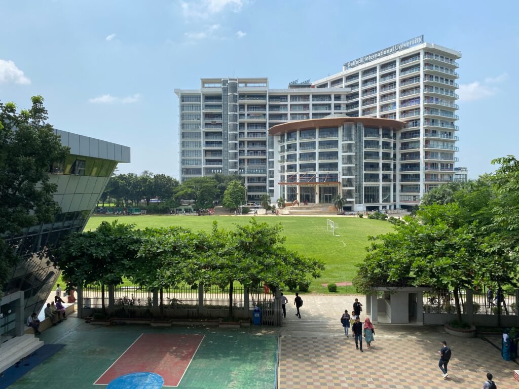 Scenic view of Daffodil International University with green field and clear sky.